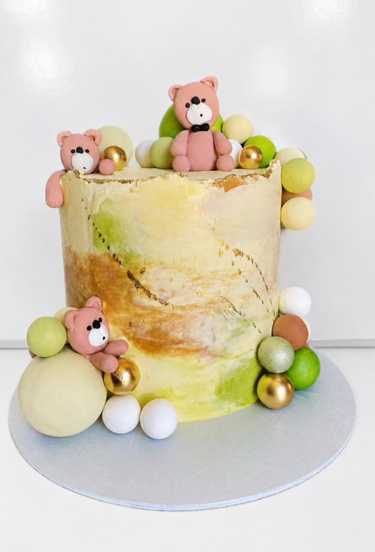 Teddy bear themed birthday cake with pastel spheres